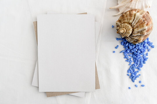 Fashionable stock stationery background - white map and seashells on a white table. Romantic background. Blank for an invitation card.