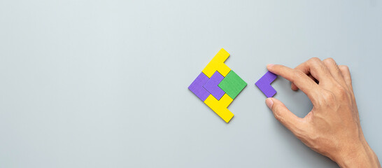 Fish shape block of colorful wood puzzle piece on gray background. logical thinking, business...