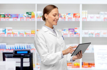 medicine, profession and healthcare concept - happy smiling female doctor or scientist in white coat with tablet pc computer over pharmacy background