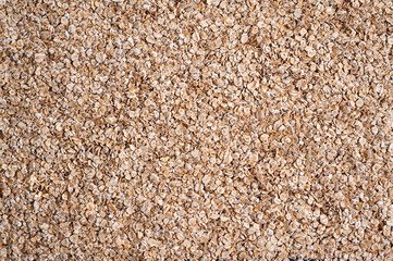 Oatmeal porridge on the table. Bunting background. View from above.