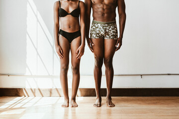 Shirtless black couple standing - Powered by Adobe