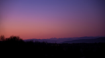colorful sky at the end of the day with mountains on the horizon