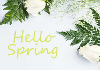 Floral arrangement frame with white roses and fern. Hello spring text