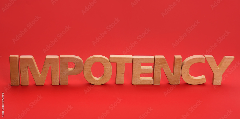 Wall mural Word IMPOTENCY made of wooden letters on red background