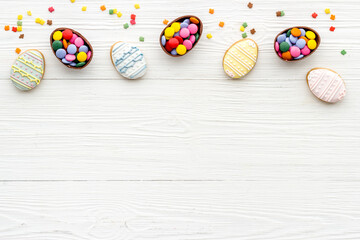 Top view of Easter cookies eggs and sweets. Space for text
