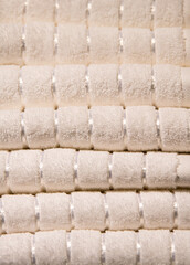 A big stack of white cream bath towels close up view