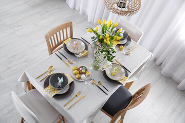 Beautiful Easter table setting with festive decor indoors, above view