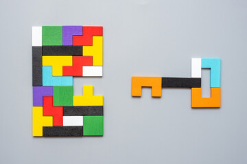 Key and keyhole shape of geometric colorful wood puzzle pieces. logical thinking, business logic,...