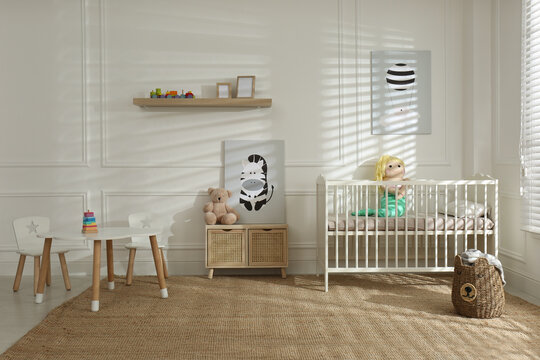 Light baby room interior with comfortable crib