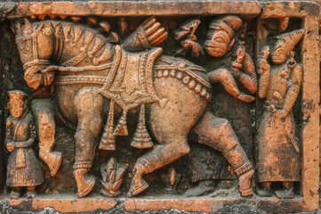 Closeup view of men with horse going hunting : terracotta carving at Kantaji aka Kantajew medieval hindu temple in Kantanagar, Dinajpur district, Bangladesh