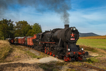 Fototapeta na wymiar historic retro steam locomotive with freight train