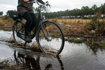 woman cycling on flooded cycle paths