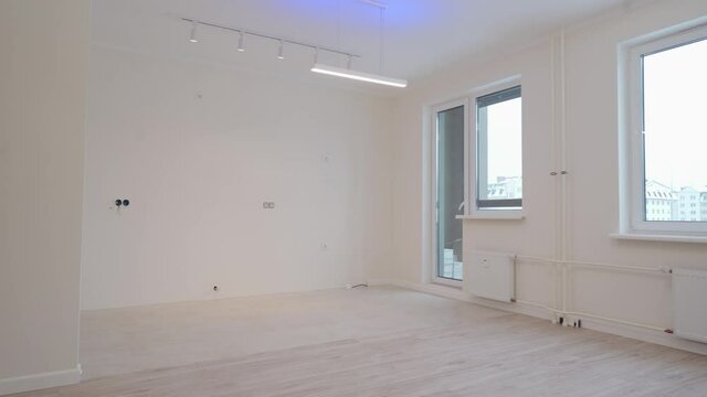 Moving in new apartment white flat interior, view of empty rooms new home construction.