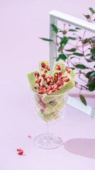 Naklejka premium Fudge, sweet candies, handmade dessert made of white chocolate, matcha tea and strawberries on a bright background.