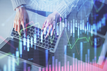 Multi exposure of woman hands working on computer and forex chart hologram drawing. Top View. Financial analysis concept.