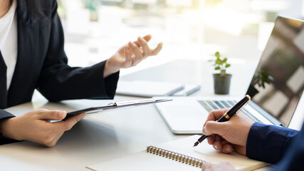 Close-up interviewers apply for jobs at the conference room in the office where job applicants are filling out resumes.