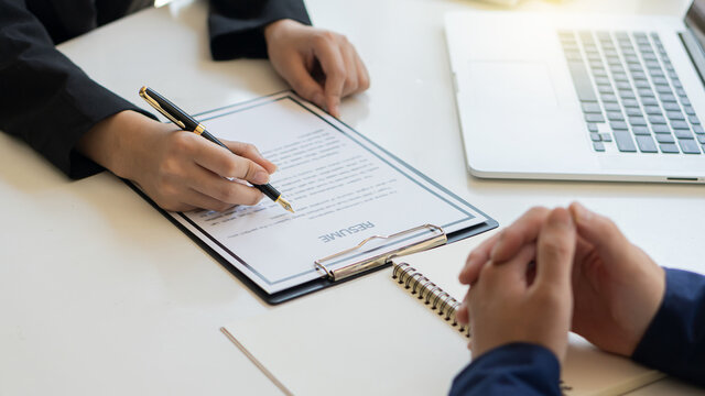 An up-close interviewer applied for a job in the office meeting room on a laptop table