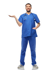 healthcare, profession and medicine concept - happy smiling doctor or male nurse in blue uniform with stethoscope holding something imaginary on empty hand over white background