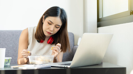 Business women work on laptop computers to eat at home in their home offices during quarantine.