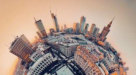 Beautiful panoramic aerial drone view on Warsaw City Skyscrapers, PKiN, and Varso Tower under construction and 19th-century tenement houses during the January sunset, Warsaw, Poland.
