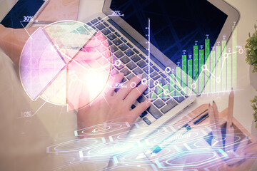 Multi exposure of woman hands typing on computer and forex chart hologram drawing. Stock market analysis concept.