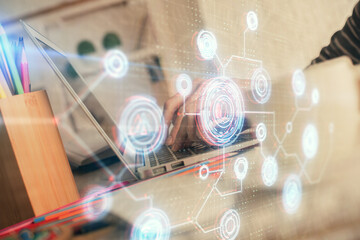Double exposure of woman hands working on computer and data theme hologram drawing. Tech concept.