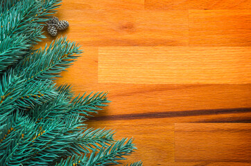 Christmas or New Year background. Spruce branches on a wood textured background. Top view, copy of the space.