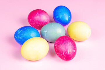 Fototapeta na wymiar Colorful painted Easter eggs decorations on light pink background.