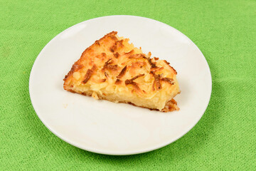 Whole cassava cake on green fabric background