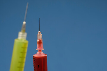 injection syringe with needle detail on colored background