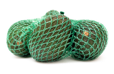 Close-up of some organic hass avocado fruits in a green mesh bag isolated on a neutral background.