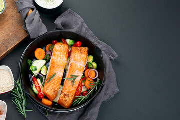 Homemade fresh salmon with starter and vegetables on dark background
