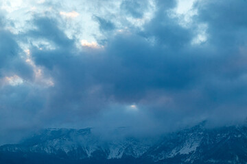 beautiful, big mountains with snow in the clouds against the blue sky with clouds on vacation, travel

