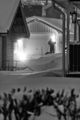 a man in the snow blast in the dark evening