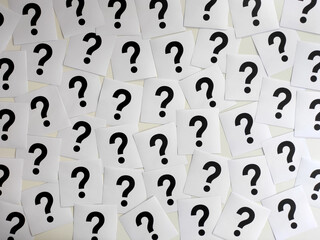 Question marks with note papers on white background