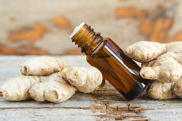 Small bottle with essential ginger oil (extract, tincture, infusion, perfume). Aromatherapy, spa...