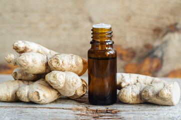 Small bottle with essential ginger oil ( extract, tincture, infusion, perfume). Aromatherapy, spa...