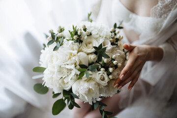 Bridal morning details. Wedding bouquet in the hands of the bride.
