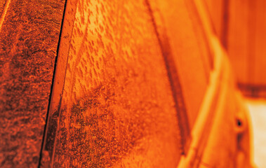 Frosting car glass at sunrise. Selective focus. Macro.
