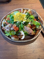 grilled chicken salad with chopped eggs, lettuce, mushrooms, potatoes and cheese.