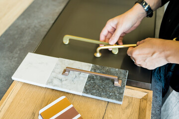 Designer woman choosing details of new kitchen in a home improvement store. Real estate, home renovation, small business concept