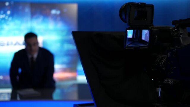 An anchorman tells the latest news in tv studio, 4k footage