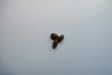 3 glossy brown softgel capsules of vitamin D3