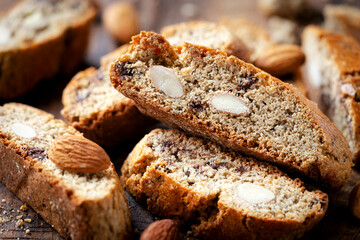 Homemade gluten free biscotti or cantuccini made of buckwheat flour with almonds and chocolate chips on dark rustic wooden background