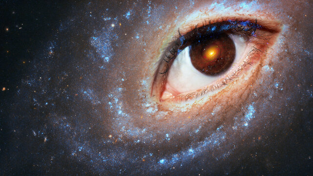 The eye of the clairvoyant in space against the background of the starry sky, the galaxy in the pupil. The concept of clairvoyance, esotericism or astrology. Elements of this image furnished by NASA.