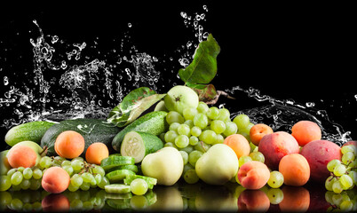 water splash fruits and vegetables on a black background, apple, cucumber, apricot, grapes, zucchini, peaches