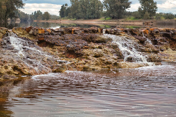 Smalls waterfalls produced by the rain in the red river.