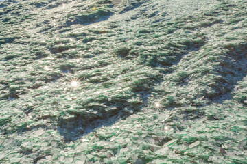 Fragments of blue glass. Small and sharp fragments of broken glass. cullet for creation of new glass are ready to be remelted.