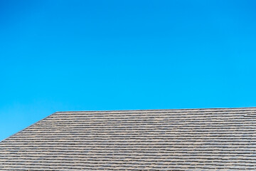 black tile roof on a new house with clear blue sky background
