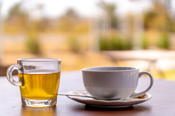 Hot coffee and tea in cup on table.